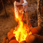 Stack heating replica bedja over a fire. Stack heating replica <em>bedja</em> over a fire.
