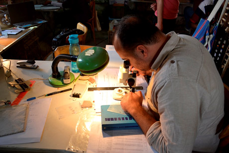 Mahmoud el –Shafey analyses ceramic fabrics using the microscope and a Mussel colour chart. Photo Sayed Salah.
